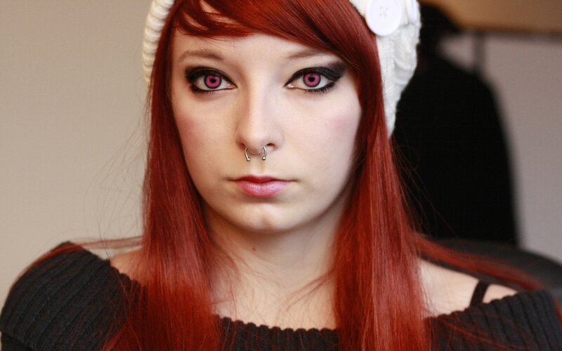 woman with red hair and pink eyes