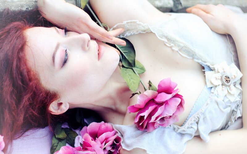 woman with red hair and pink roses