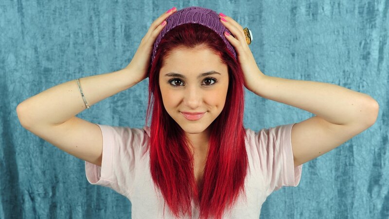 woman with red hair and purple hat