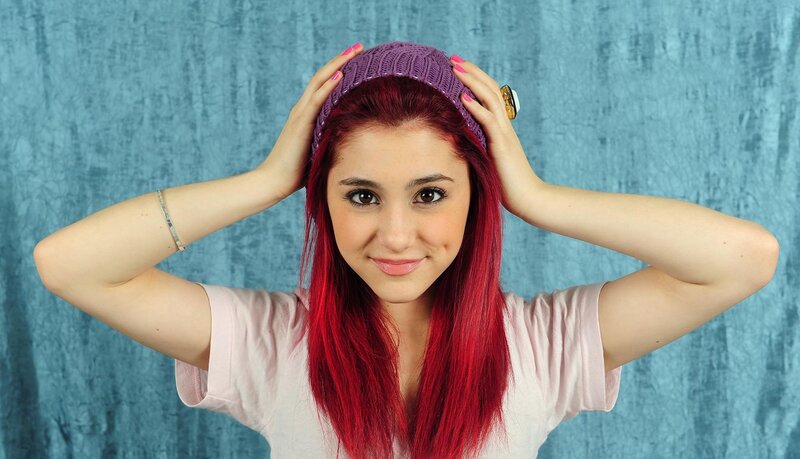 woman with red hair and purple hat