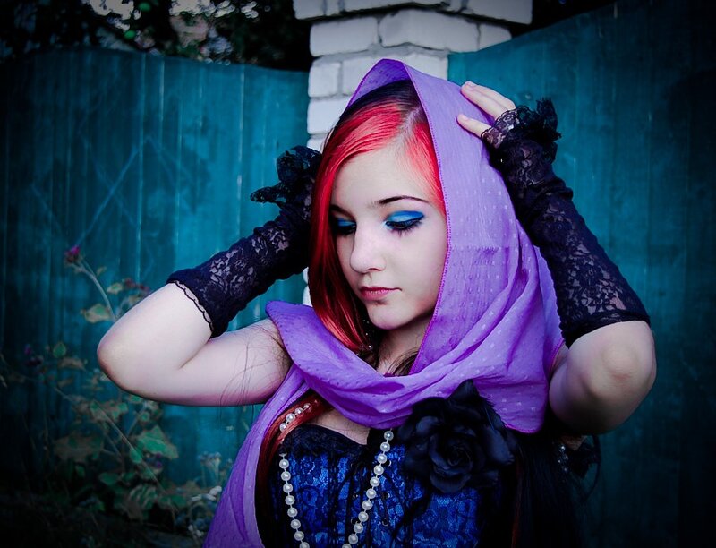 woman with red hair and purple scarf