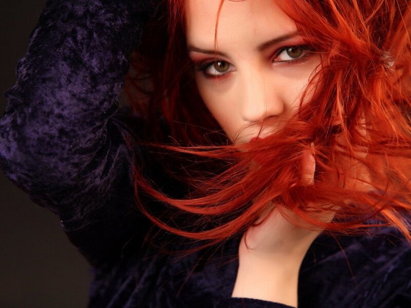 woman with red hair and purple top