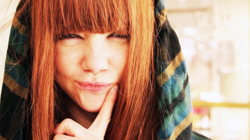 woman with red hair and scarf