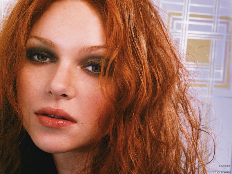 woman with red hair and smoky eyes