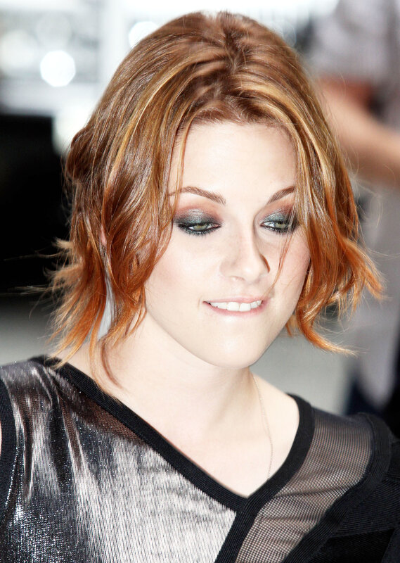 woman with red hair and smoky eyes