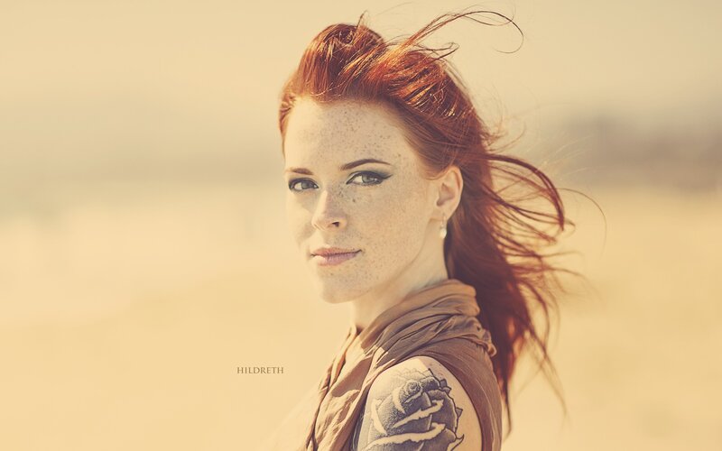woman with red hair and tattoo