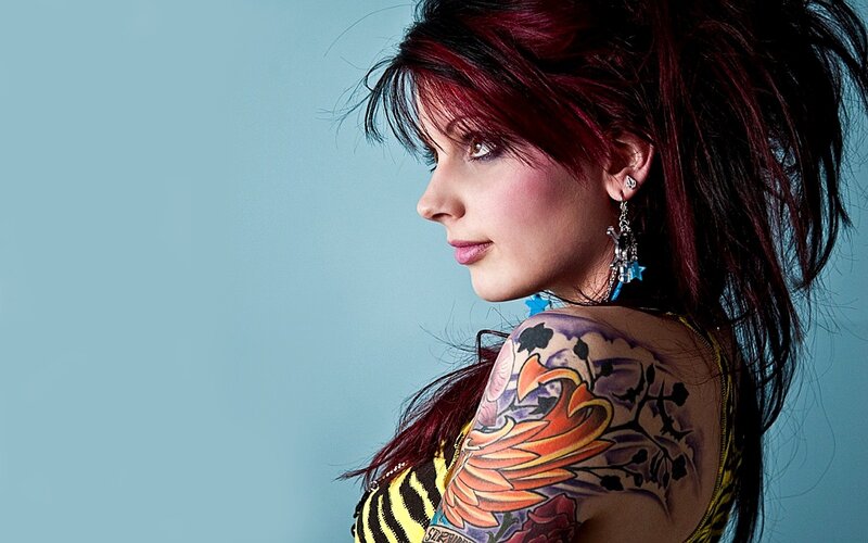 woman with red hair and tattoo