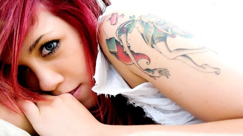 woman with red hair and tattoo