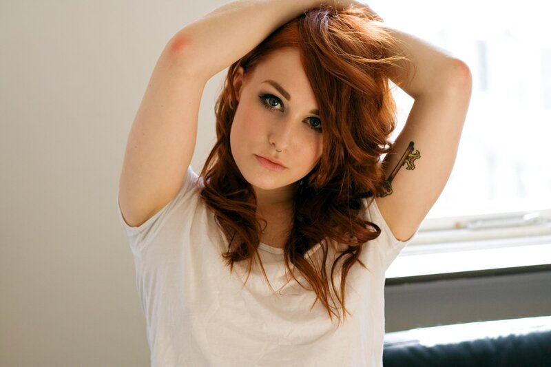 woman with red hair and tattoo