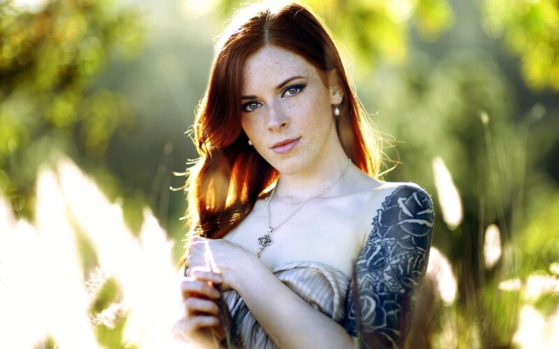 woman with red hair and tattoo