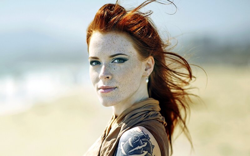 woman with red hair and tattoo