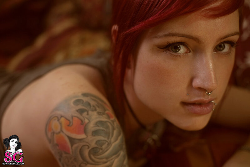 woman with red hair and tattoo