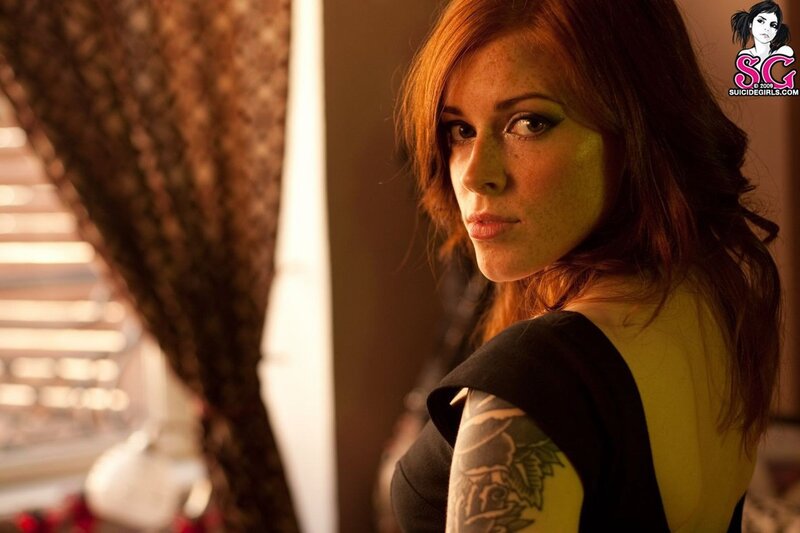 woman with red hair and tattoo