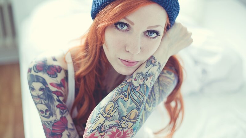woman with red hair and tattoos