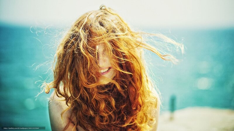 woman with red hair at beach
