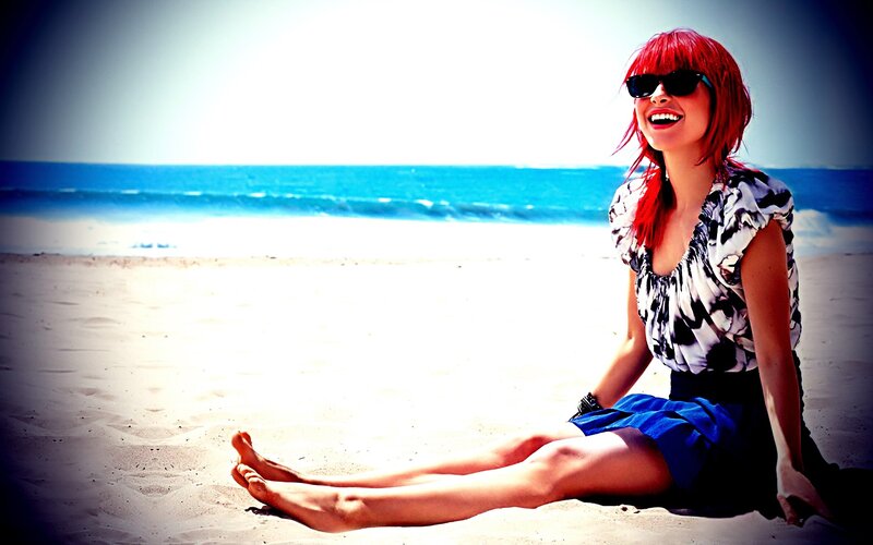 Woman with red hair at the beach