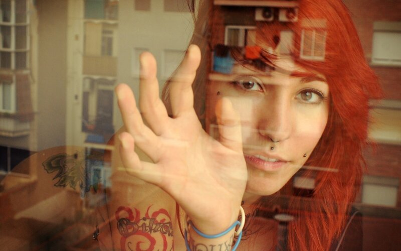 woman with red hair at window