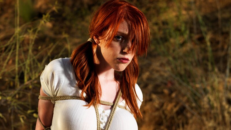 Woman with red hair bound by rope
