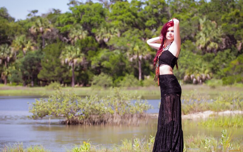 Woman with red hair by a lake