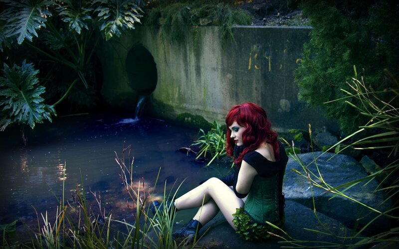 Woman with red hair by a stream