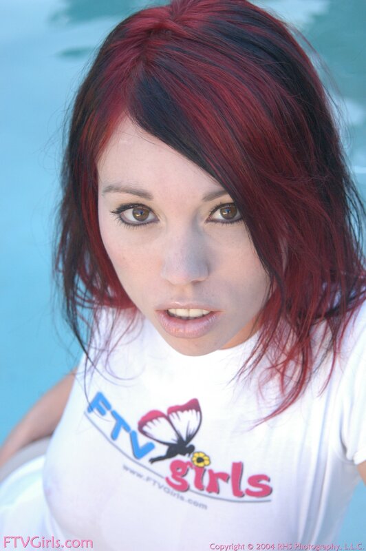 woman with red hair by pool