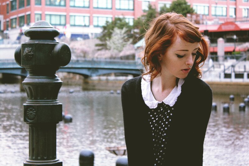 woman with red hair by the water