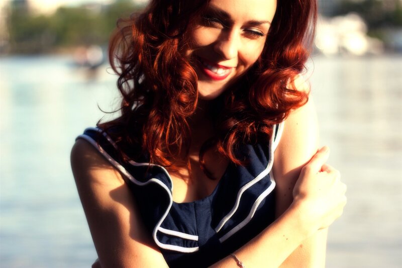 woman with red hair by the water