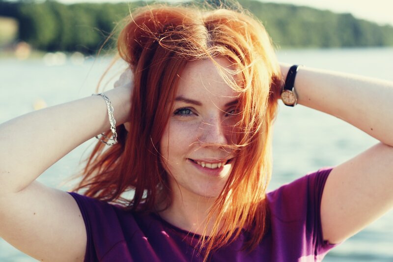 Woman with red hair by the water