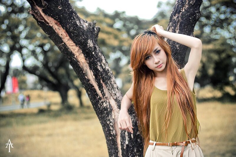 woman with red hair by tree