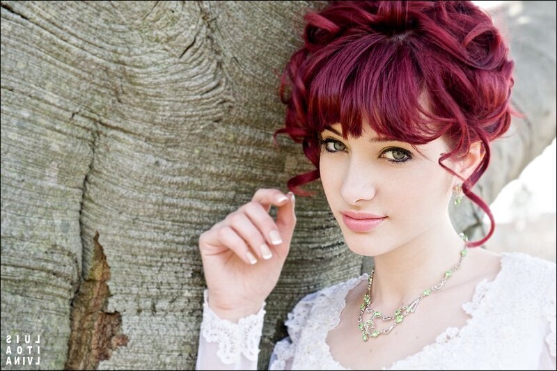 woman with red hair by tree