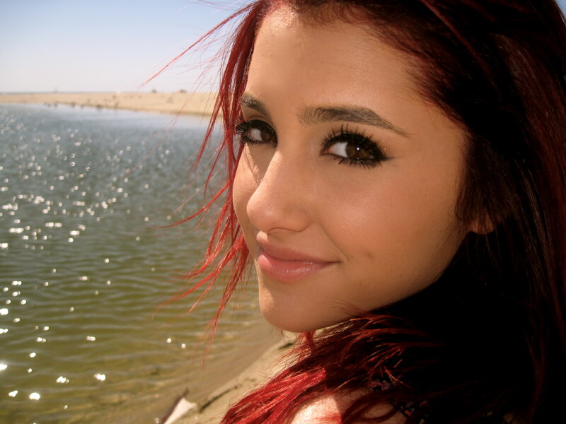 woman with red hair by water