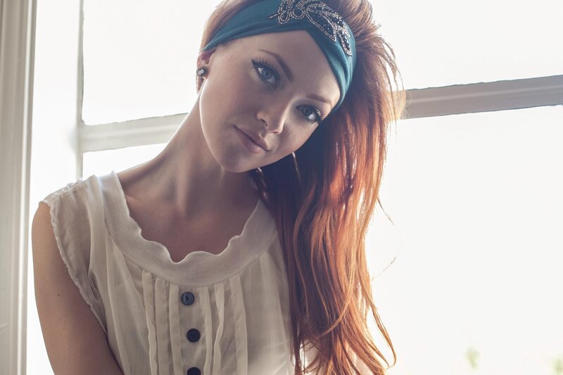 woman with red hair by window
