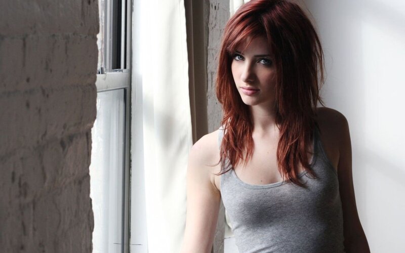 woman with red hair by window