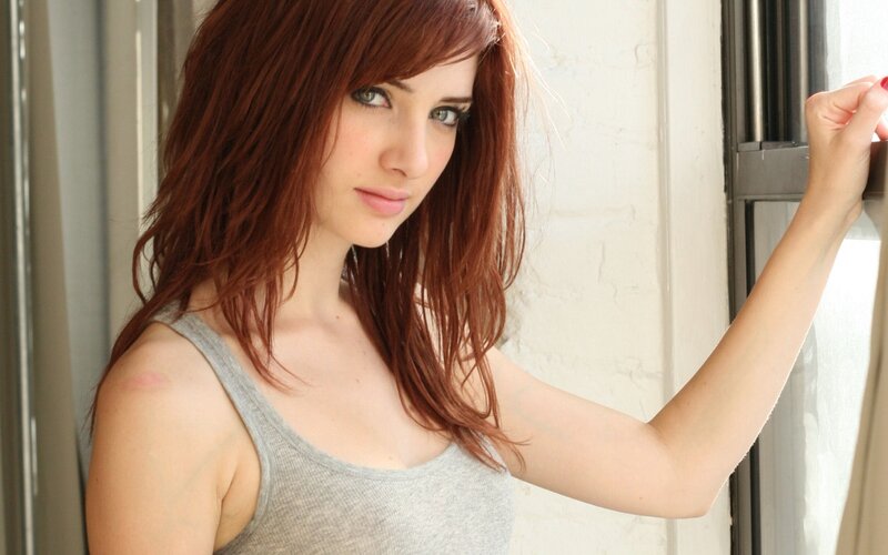 woman with red hair by window