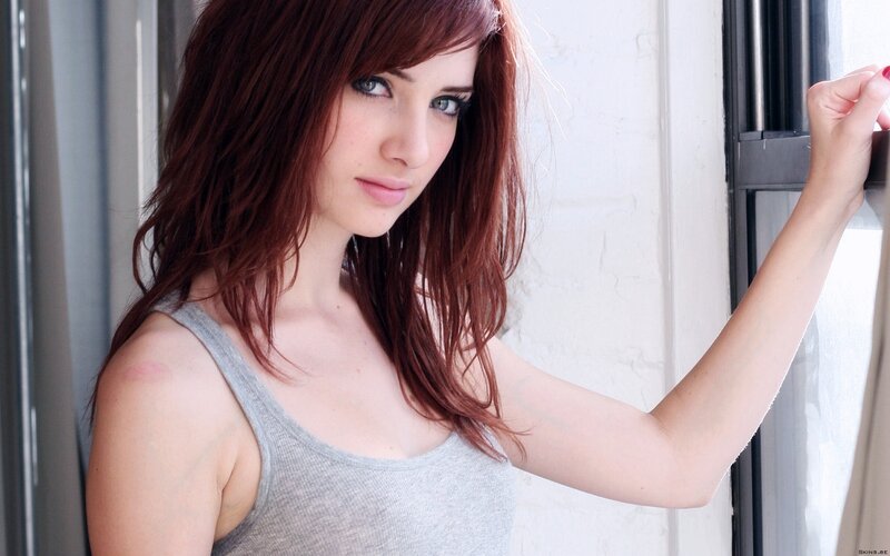 woman with red hair by window