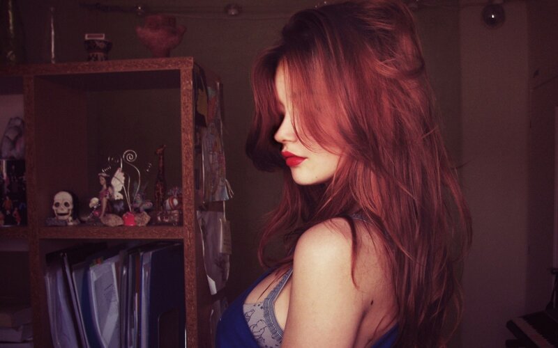 Woman with Red Hair — Dramatic, Night, Photograph, Bookshelf, Skull