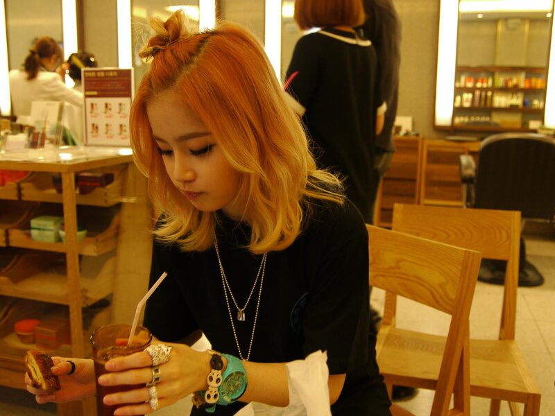 woman with red hair drinking soda