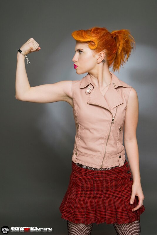 woman with red hair flexing