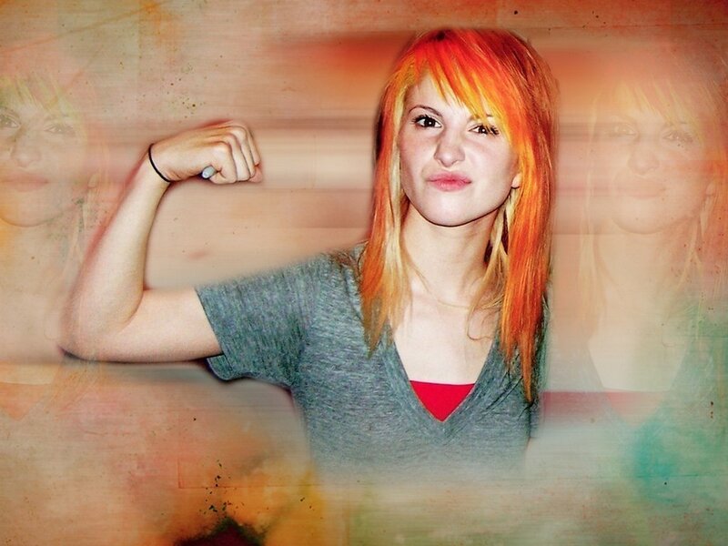 woman with red hair flexing