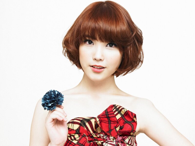 woman with red hair holding flower