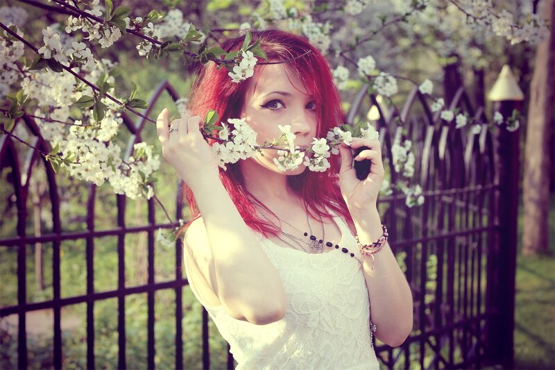 woman with red hair holding flowers