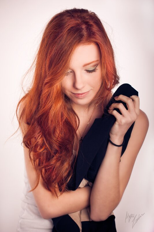 woman with red hair holding jacket
