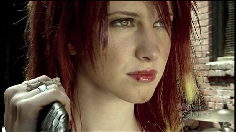 woman with red hair holding object