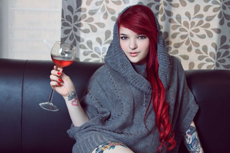 Woman with red hair holding wine glass