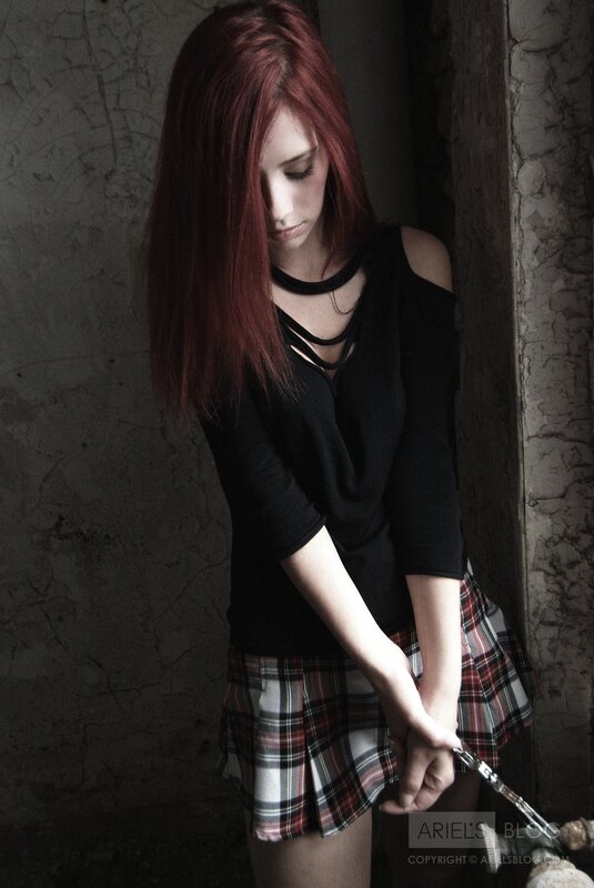 woman with red hair in a dark room