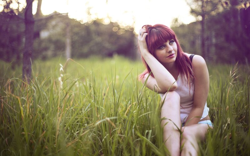 woman with red hair in a field