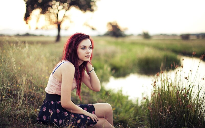 woman with red hair in a field