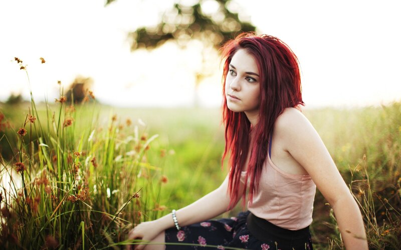 woman with red hair in a field