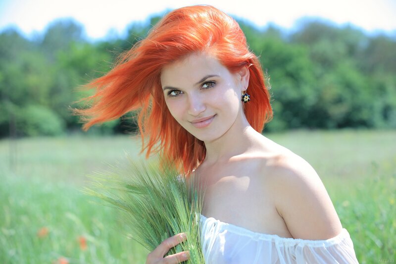 Woman with red hair in a field