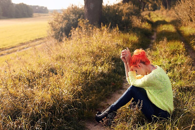 Woman with red hair in a field